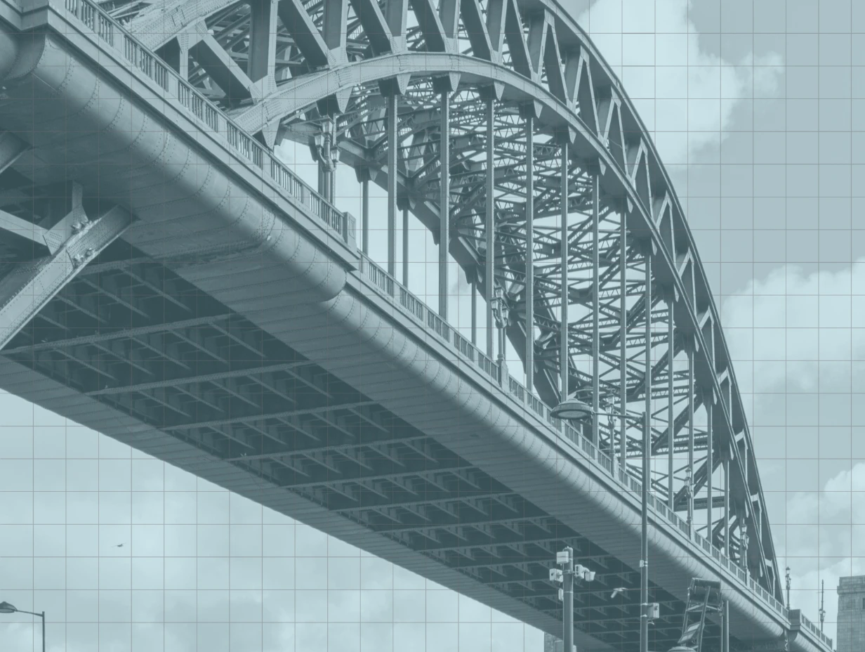 The steel arch and deck of the Tyne Bridge seen from below, toned blue-grey under a faint grid.